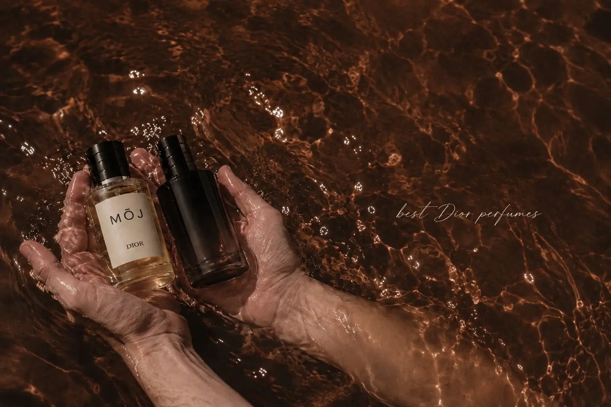 Hands holding a MOJ Dior inspired perfume beside a Dior bottle in sunlit water
