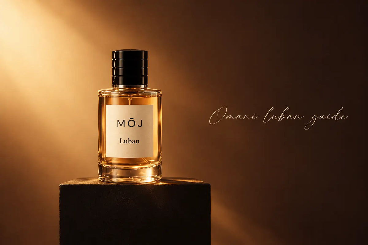 MOJ Luban perfume bottle lit in warm amber light on a dark plinth